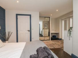 A bedroom with a bed and a desk at Coral Villa in Bridlington