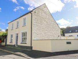 A house with white walls and several windows at Station Hall in Cilgerran