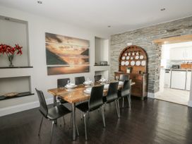 A dining room with a table and chairs at Station Hall in Cilgerran