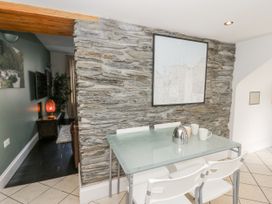 A dining room with a table and chairs at Station Hall in Cilgerran