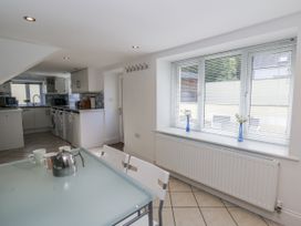 A kitchen with a table and kettle at Station Hall in Cilgerran
