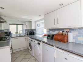 A kitchen with appliances and a window at Station Hall in Cilgerran