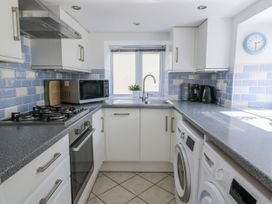 A kitchen with appliances and cabinetry at Station Hall in Cilgerran