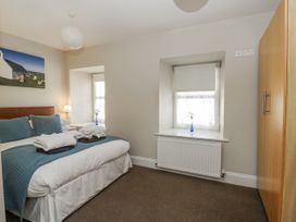 A bedroom with a double bed and a window at Station Hall in Cilgerran
