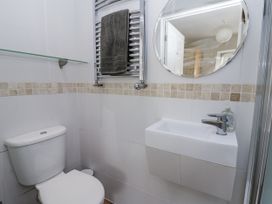A bathroom featuring a toilet, sink, and towel rack at Station Hall in Cilgerran