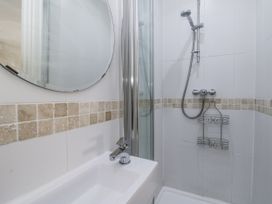 A bathroom with a shower and sink at Station Hall in Cilgerran