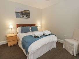 A bedroom with a bed and bedside lamps at Station Hall in Cilgerran