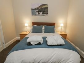 A bedroom with a bed and bedside lamps at Station Hall in Cilgerran