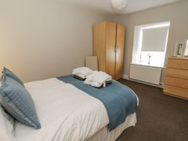 A bedroom with a bed and wardrobe at Station Hall in Cilgerran