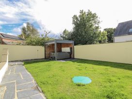 A garden with a hot tub and grass at Station Hall in Cilgerran