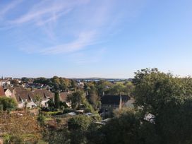 A view of houses and trees with ocean in the distance at 9 Brython Place Tenby