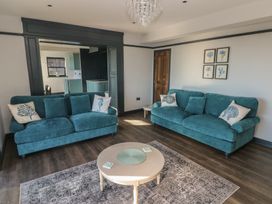 A living room with sofas and a coffee table at 9 Brython Place in Tenby