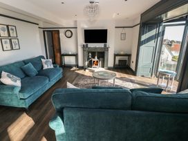 A living room with a sofa and coffee table at 9 Brython Place Tenby