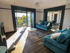 A living room with a sofa and coffee table at 9 Brython Place Tenby