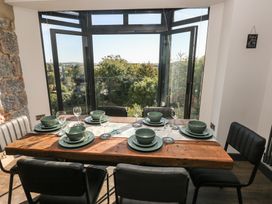 A dining room with a table set for dinner at 9 Brython Place in Tenby