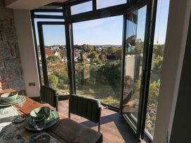 A dining room with a view of a garden at 9 Brython Place Tenby