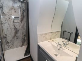 A bathroom with a shower and sink at 9 Brython Place Tenby