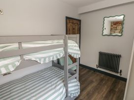A bedroom with a bunk bed and a mirror at 9 Brython Place in Tenby