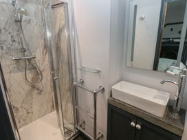 A bathroom with a shower and sink at 9 Brython Place Tenby