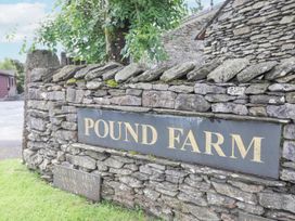 A stone wall with a sign for Pound Farm near Crook in Kendal