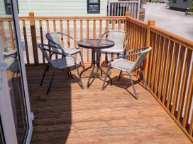 An outdoor seating area with a table and chairs at 31 Forest Views, Moota near Aspatria