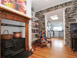 A living room with a fireplace and shelves at 2 Glyddins 1910 in Rock