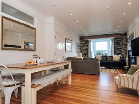 A dining area and living room with seating and a TV at 2 Glyddins 1910 in Rock