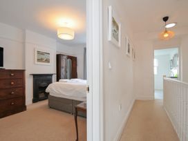 A bedroom with a bed and wardrobe at 2 Glyddins 1910 in Rock