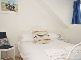 A bedroom with a bed and bedside table at 2 Glyddins 1910 in Rock