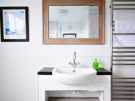 A bathroom with a sink and mirror at 2 Glyddins 1910 in Rock