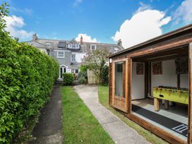 A backyard with a shed containing a foosball table at 2 Glyddins 1910 Rock