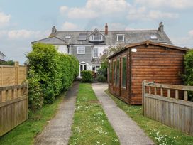 A garden with a pathway and shed at 2 Glyddins 1910 Rock