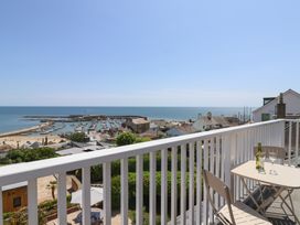 A balcony view overlooking the ocean and harbor at 3 Harbour Heights Lyme Regis
