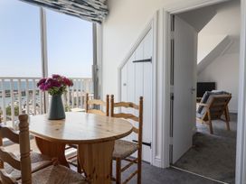 A dining room with a table and chairs at 3 Harbour Heights Lyme Regis