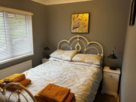 A bedroom with a bed and side table at 22 Two Little Ducks in Lynton