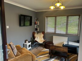 A snug with a television and seating at 22 Two Little Ducks in Lynton