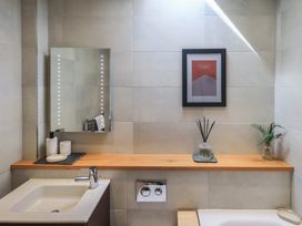 A bathroom with a sink and mirror at Haystacks in Troutbeck
