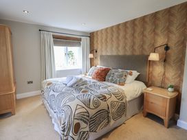A bedroom with a bed and bedside table at Haystacks in Troutbeck