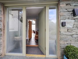 An entrance with a front door and stone walls at Haystacks in Troutbeck