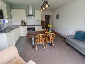 A kitchen with a dining table and chairs at Honeysuckle Cottage in Crookham near Cornhill-On-Tweed