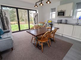A dining room with a table and chairs at Honeysuckle Cottage in Crookham near Cornhill-On-Tweed