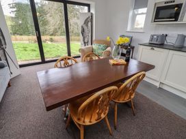 A dining room with a table and chairs at Honeysuckle Cottage in Crookham near Cornhill-On-Tweed