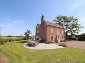 A house with a patio and dining table at Daniels Farmhouse in Claines