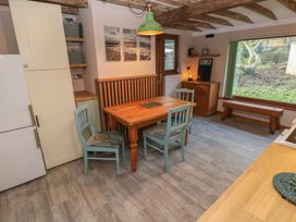 A dining room with a table and chairs at 2 Strand Cottages in Carmarthen