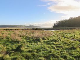 A view of grassland and waterway with hills at 2 Strand Cottages in Carmarthen