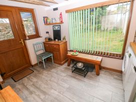 A kitchen with door and window at 2 Strand Cottages in Laugharne