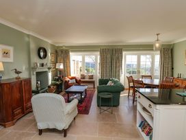 A living room with sofas and a dining area at Roding Cottage in Egton
