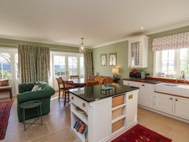 A kitchen with a dining table and chairs at Roding Cottage in Egton