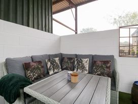 A seating area with a sofa and table at The Hay Barn in Huntley