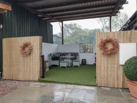 An outdoor area with seating and plants at The Hay Barn in Huntley